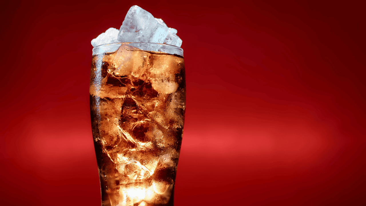 Glass filled with ice and cola drink