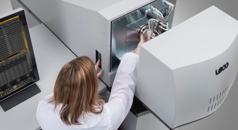 Analyst loading LECO GDS900 sample
