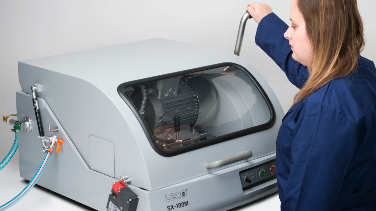 person operating metallography saw