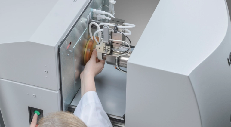 analyst loading sample into glow discharge spectrometer