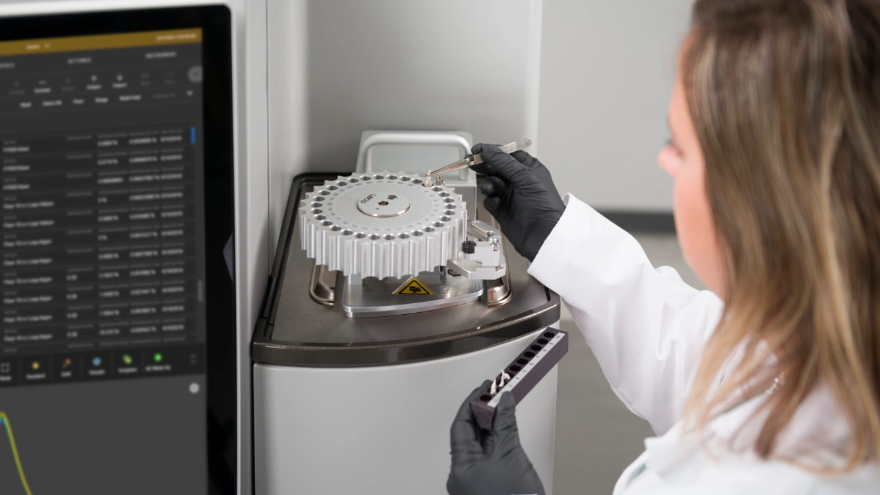 scientist placing sample LECO 828 series elemental analyzer