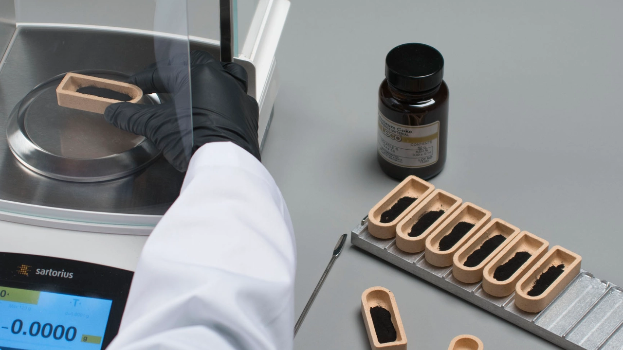 Scientist placing sample crucible into scale chamber