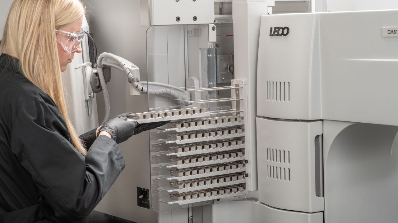 LECO lab technician loads samples into the CM812 auto sampler