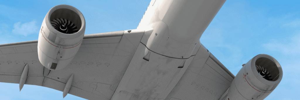 Wide shot of an airplane flying overhead, showing both turbines made with superalloy high-perfomance materials in the blue sky.