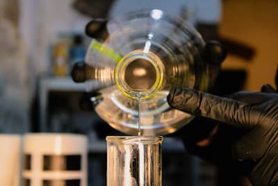Scientist pouring chemicals